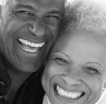 Happy african-american couple with all-on-four dental implants