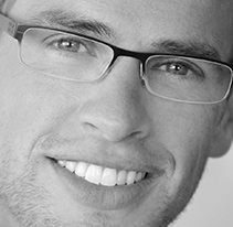 Smiling young man with dental implants
